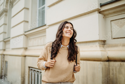 Young caucasian smiling woman student going to university 