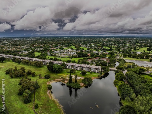 Aerial view of a suburban landscape with lush greenery under a cloudy sky. Lauderhill, Florida