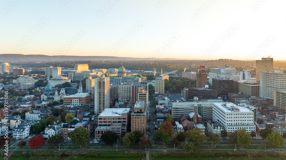 Fototapeta premium Aerial view of downtown Harrisburg, Pennsylvania, at sunrise, showcasing the city’s historic buildings and streets.