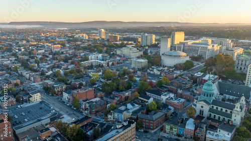 Aerial view of downtown Harrisburg, Pennsylvania, at sunrise, showcasing the city’s historic buildings and streets.