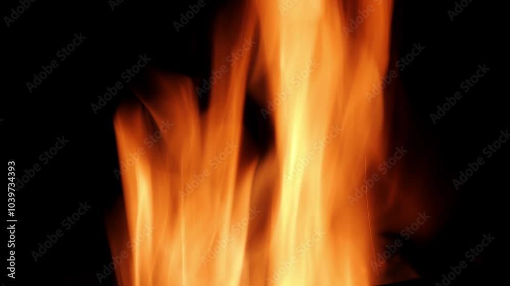 Close-up fire flames on the dark. Beautiful bright orange coloured. Large and moving aggresively. Close-up fire flames on the dark. Beautiful bright orange coloured. Large and moving aggresively.
