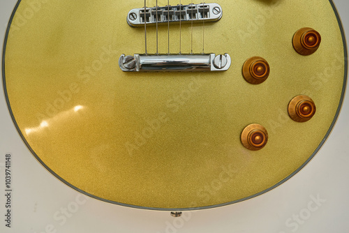 Close-up photograph of a vintage gold-plated electric guitar, details photo