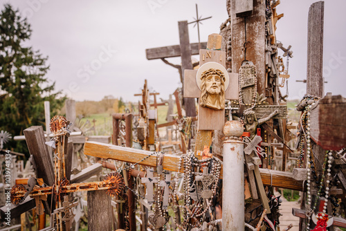 A large collection of wooden crosses, crucifixes, and rosaries displayed at Kryžių Kalnas (Hill of Crosses), symbolizing faith, devotion, and pilgrimage.