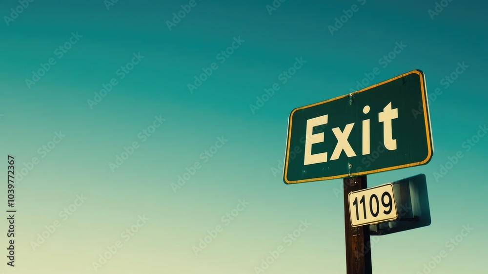 Green exit sign with clear blue sky in background Green exit sign with clear blue sky in background