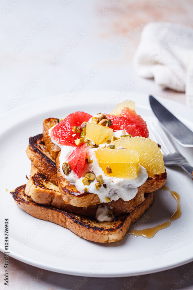 French toast with cream and citrus slices.