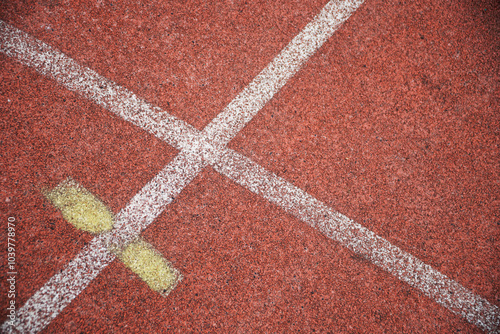 Crossing markings on a red cinder track for track and field athletes. Photo photo