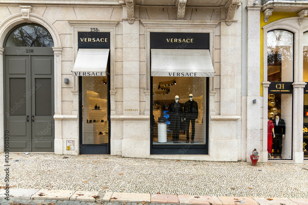 Versace letters logo above the shop window on black background. Versace ...