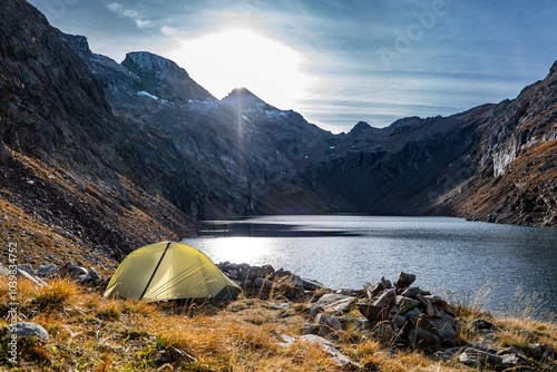 A tent by a high altitude lake in the Alps