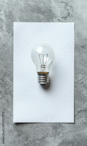 Lightbulb on a white sheet of paper.