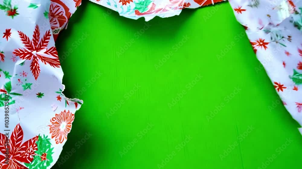 Unwrapping Christmas wrapping paper on green screen. Unwrapping gift revealing a green screen. Craft paper gift wrapping, Christmas holiday concept. Copy space