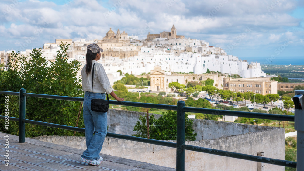 Exploring the charming hilltop town of Ostuni in Puglia, Italy on a sunny afternoon Exploring the charming hilltop town of Ostuni in Puglia, Italy on a sunny afternoon