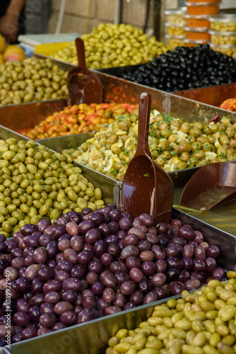 Bins piled high with freshly pickled green, black and purple kalamata olives. photo