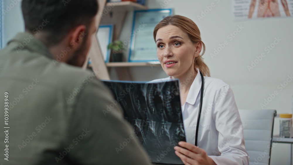 Healthcare worker communicating patient analyzing x-ray. Closeup woman doctor Healthcare worker communicating patient analyzing x-ray. Closeup woman doctor