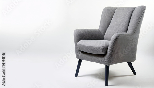 Relax in style with this elegant grey armchair.  Its soft fabric and modern design create a calming atmosphere. Perfect for any home!