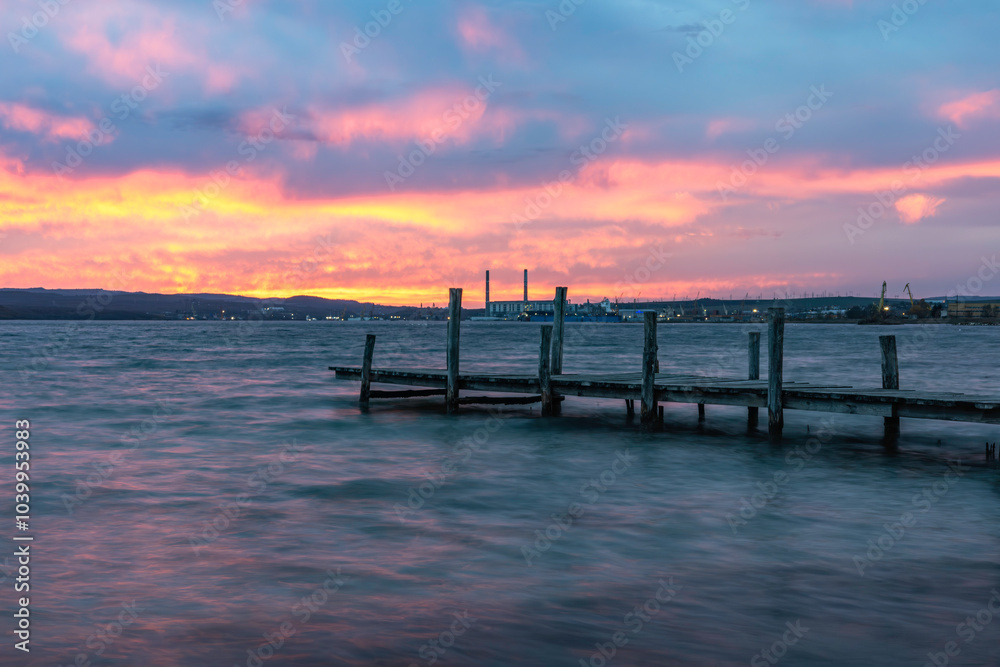 Magnificent sunset, wooden Pier on the lake. A tranquil sunset over a Varna lake. Magnificent sunset, wooden Pier on the lake. A tranquil sunset over a Varna lake.