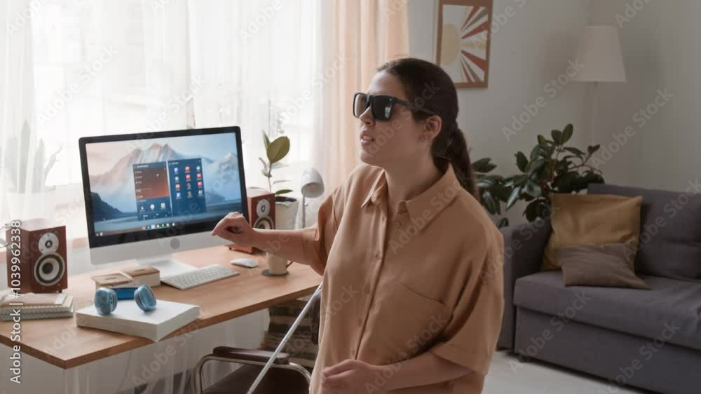Cheerful young woman with visual impairment dancing to pop music in living room Cheerful young woman with visual impairment dancing to pop music in living room