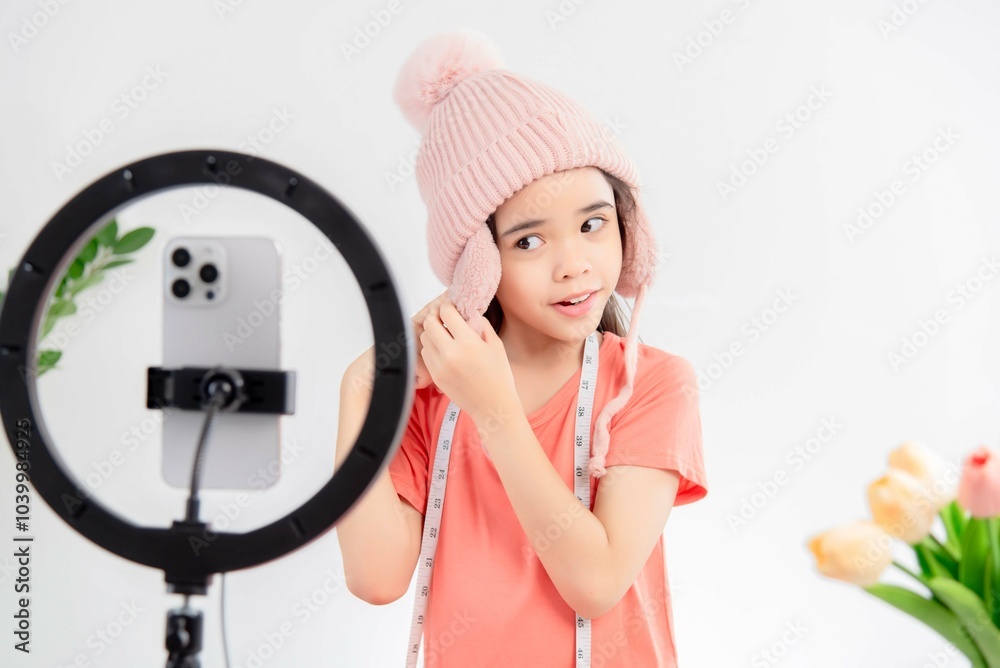 social media market concept. Asian cute girl seller showing clothes during live streaming in the mobile application. social media market concept. Asian cute girl seller showing clothes during live streaming in the mobile application.