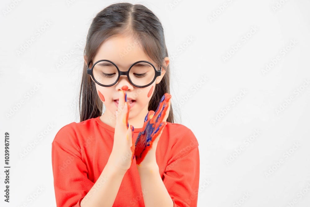 Little girl with hands painted in colorful paint. Little girl with hands painted in colorful paint.