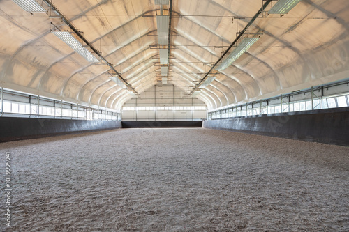 Empty horse riding arena indoor without people
