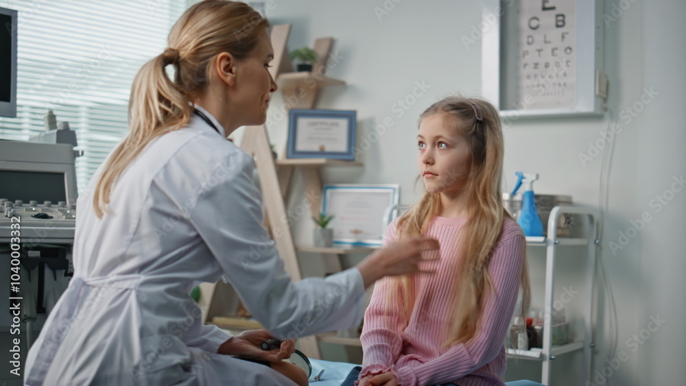 Doctor consulting young girl in modern medical office. Smiling pediatrician talk Doctor consulting young girl in modern medical office. Smiling pediatrician talk