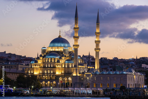 Yeni Cami Mosque in Istanbul, Turkey, illuminated by lights at dusk photo