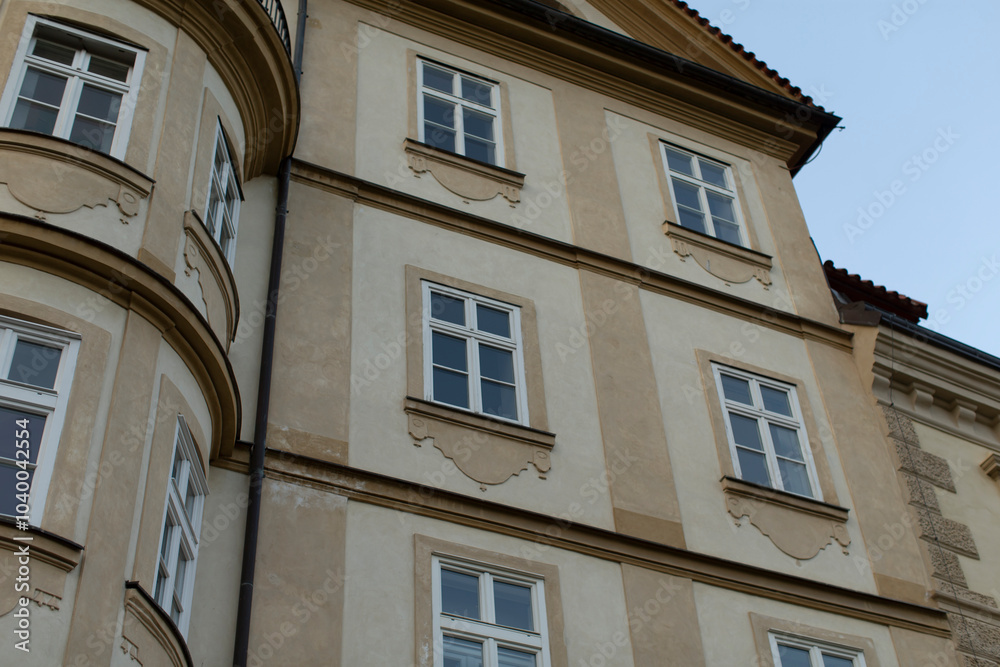A detailed closeup view of the intricate facade design showcasing beautiful windows and decorative elements A detailed closeup view of the intricate facade design showcasing beautiful windows and decorative elements