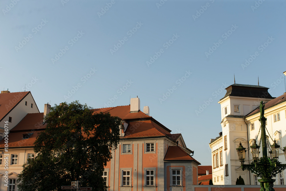 Enjoy stunning views of traditional buildings and a bright sky in a charming European town with picturesque streets Enjoy stunning views of traditional buildings and a bright sky in a charming European town with picturesque streets