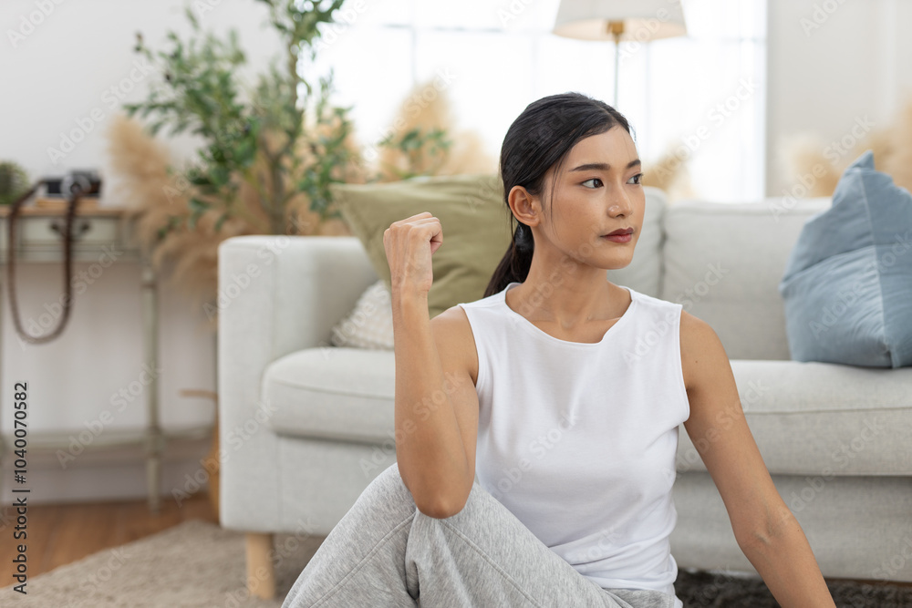 young asian female twist body stretching practicing yoga sitting on floor in living room at home. Relax and stretch and workout morning at home. Activity body movement exercises. young asian female twist body stretching practicing yoga sitting on floor in living room at home. Relax and stretch and workout morning at home. Activity body movement exercises.