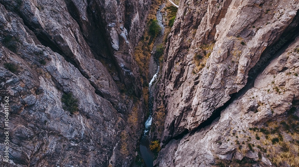 Aerial View of a Narrow Canyon with Steep Walls and Flowing River Aerial View of a Narrow Canyon with Steep Walls and Flowing River