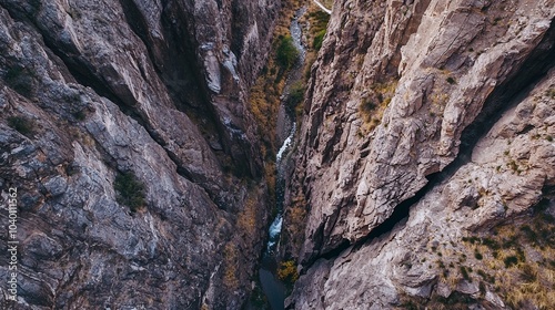 Aerial View of a Narrow Canyon with Steep Walls and Flowing River