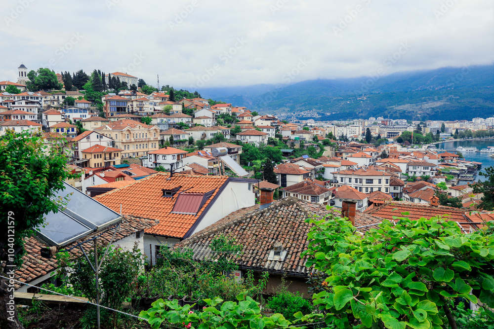 Fototapeta premium Vibrant overview of Ohrid Macedonia showcasing terracotta rooftops and lush greenery under cloudy skies