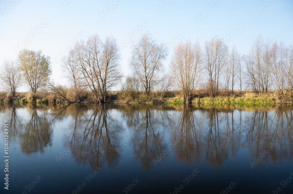The bank of a quiet river in autumn. The bank of a quiet river in autumn.