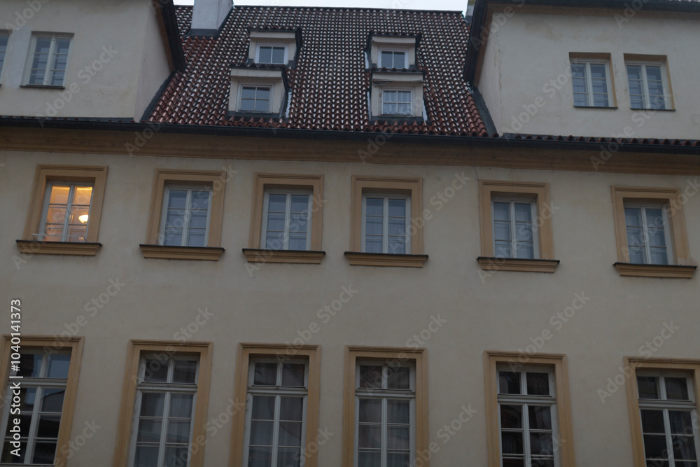 Fototapeta premium An impressive architectural facade showcases intricately designed windows along with a truly unique rooftop structure