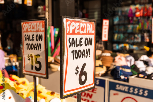 special sale signs in golden sunlight in front of a shop