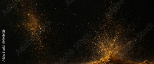 Abstract view of shimmering gold dust scattered against a black background