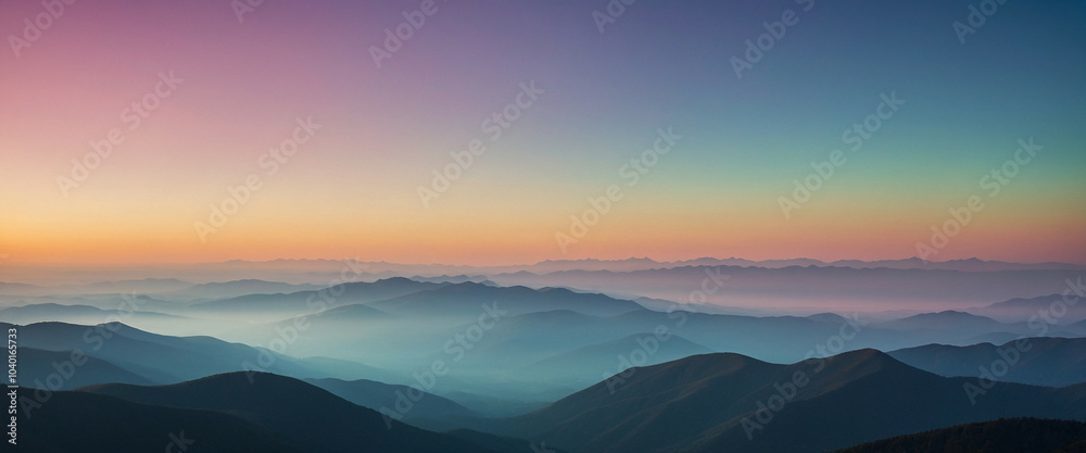 A soft gradient sky over rolling mountain ranges A soft gradient sky over rolling mountain ranges