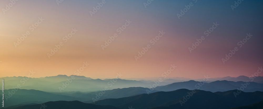 Soft gradient landscape at dusk with rolling hills under a colorful sky Soft gradient landscape at dusk with rolling hills under a colorful sky