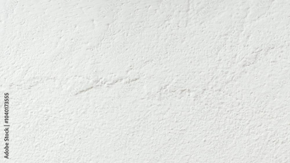  The wall is painted with white paint with a visible texture