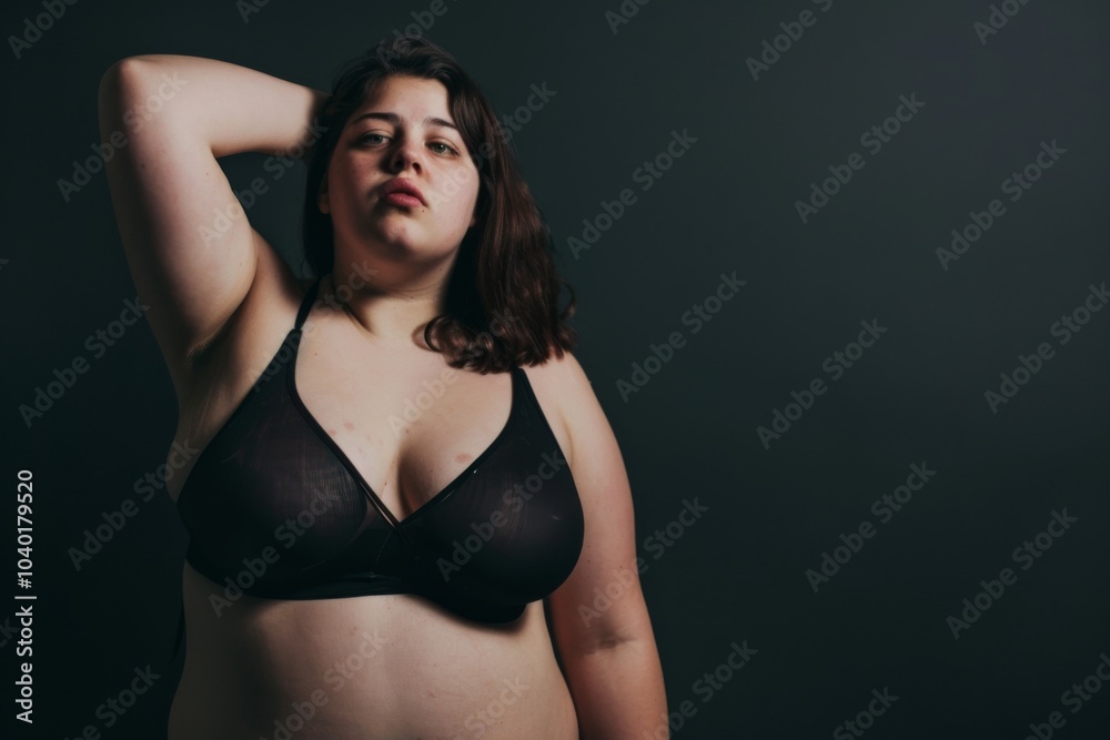 Empowered plus size woman confidently embraces her body against a minimalist studio backdrop in stylish underwear Empowered plus size woman confidently embraces her body against a minimalist studio backdrop in stylish underwear
