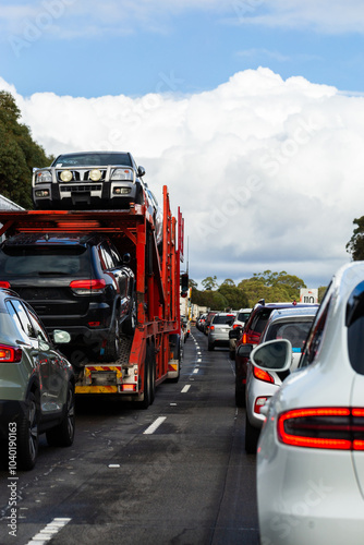 Truck transporting cars and traffic stopped on highway headed into Sydney photo