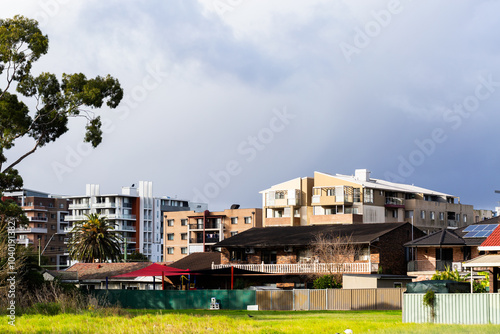 City building sin Sydney suburb with dramatic sky above photo