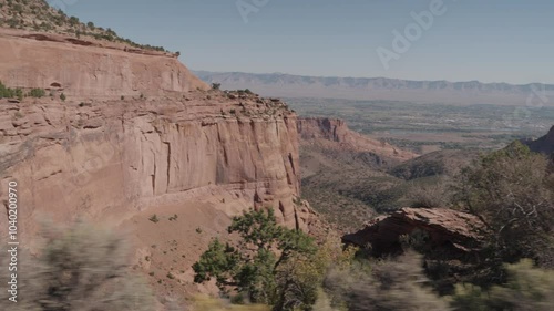 Colorado National Monument Park near the city of Grand Junction. Sheer-walled, Red rock canyons, Rim Rock Drive, Towering monoliths within a vast plateau and canyon panorama USA