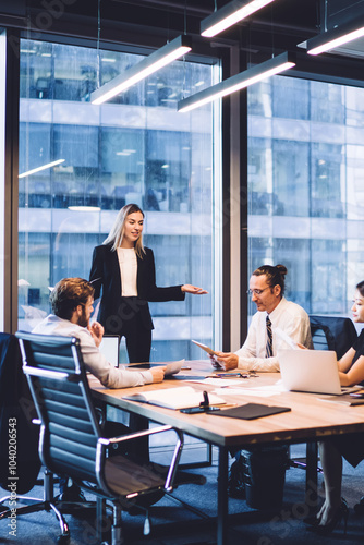 Professional financial experts collaborating during brainstorming meeting listening information from clever female director, businesswoman providing information to corporate workers of company