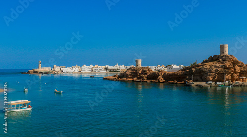 Wallpaper Mural A serene view of Sur Oman showcasing traditional boats and stunning coastal architecture under a clear blue sky Torontodigital.ca
