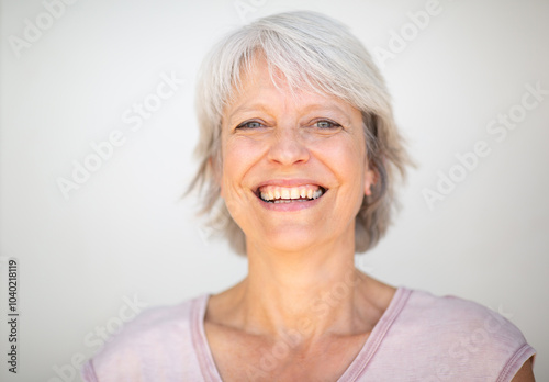 Happy senior woman with short grey hair and a bright smile