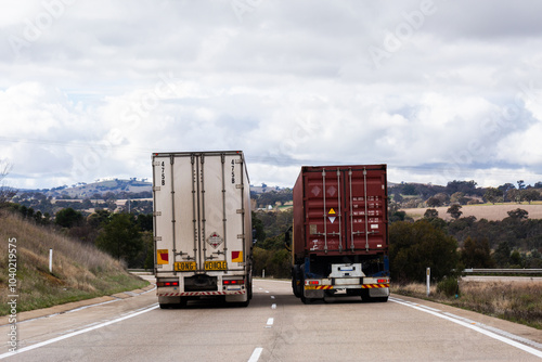 Trucks on rural Australian highway transporting goods across NSW Australia photo