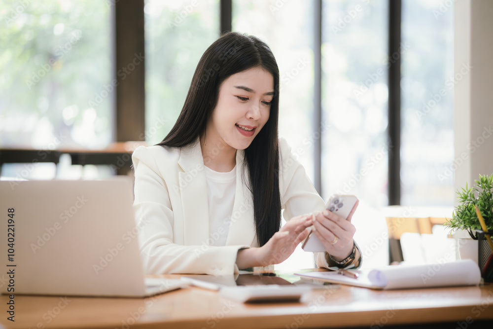 Asian accountant using laptop computer to analyze sales growth in global workplace market. Accounting concept. Asian accountant using laptop computer to analyze sales growth in global workplace market. Accounting concept.