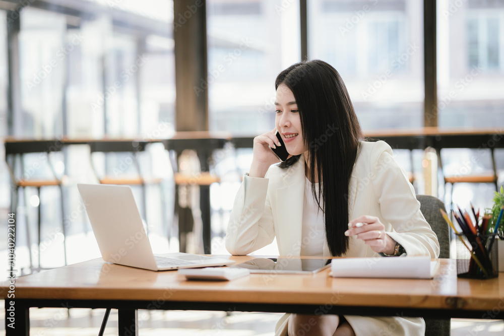 Asian accountant using laptop computer to analyze sales growth in global workplace market. Accounting concept.