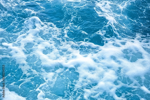 blue ocean water with white foam waves background