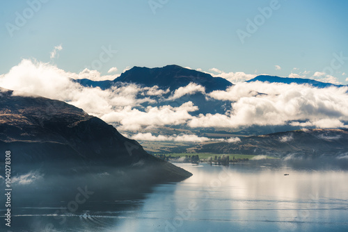 Scenic foggy mountain from summit of Roys Peak with Lake Wanaka in the morning at New Zealand photo